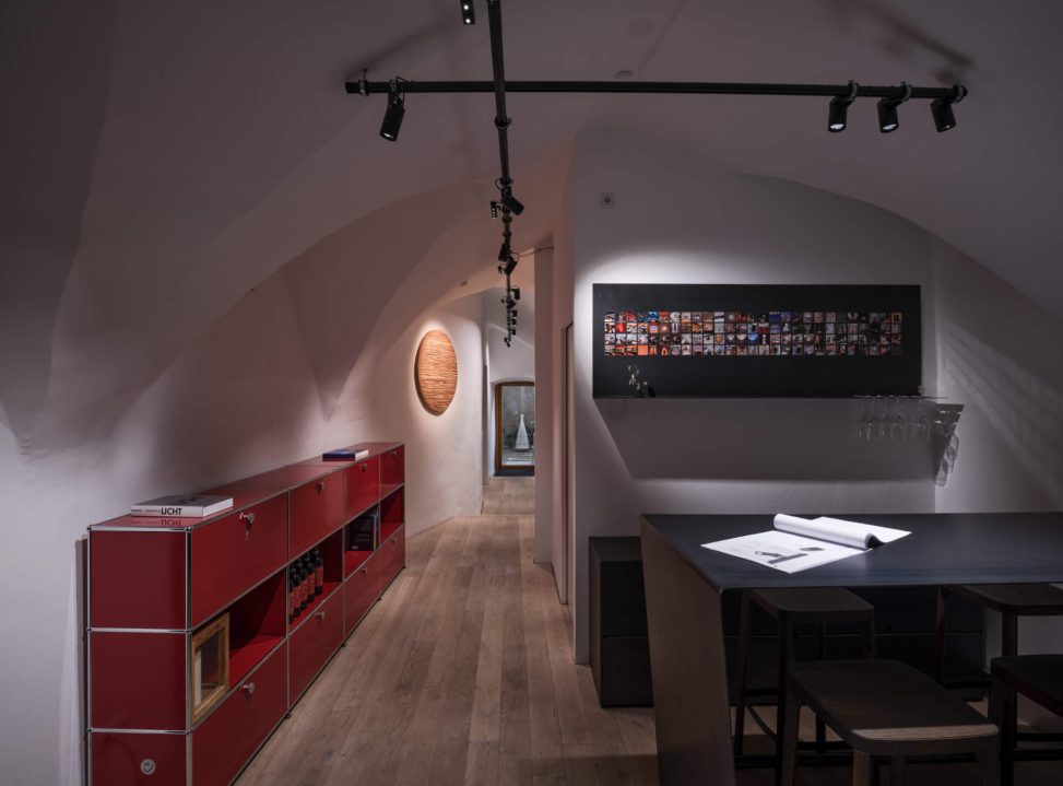 Moderner Raum mit gezielter Beleuchtung, stilvollen Möbeln und künstlerischen Akzenten.